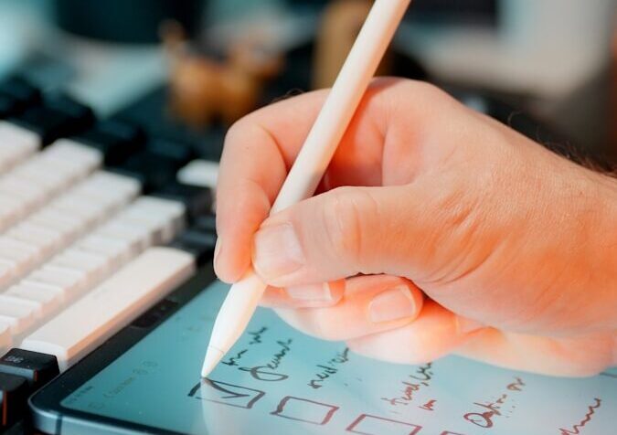 Someone is using a stylus on a tablet.